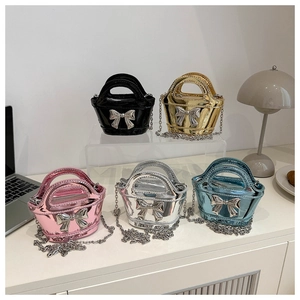 Detail of metallic girls' mini handbags with silver bows and chain straps in five colors