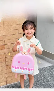 Detail of pink cartoon rabbit egg-shell backpack with 3D ears and polka dot bow
