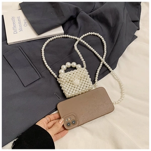 Détail du mini sac en perles avec fermoir fleur de camélia et bandoulière