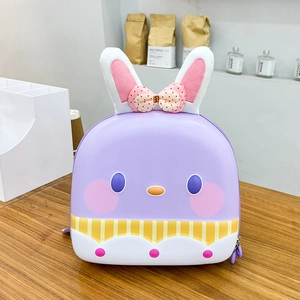Detail of purple cartoon rabbit hard shell backpack showing 3D ears and cute bow accent