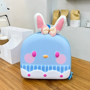 Detail of blue hardshell kids backpack featuring 3D rabbit ears and a cartoon face design
