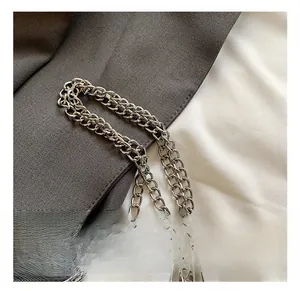 Macro shot of polished silver metal chain strap with glossy finish for handbag detail