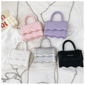 Detail view of mini wavy flap bags with chain straps in multiple pastel colors