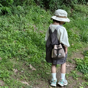 Boy's khaki mesh drawstring crossbody bag with outdoor cargo outfit and sun hat
