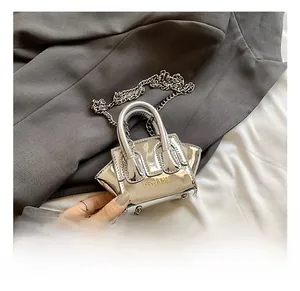 Detail view of silver laser reflective mini bag with chain strap and top handles