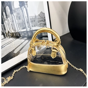Detail of a shell-shaped transparent jelly bag with golden leather and metal chain strap