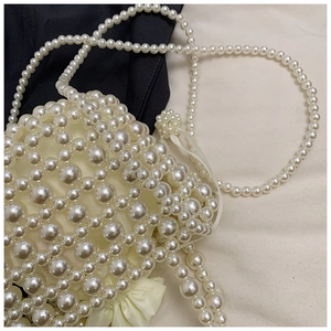 Gros plan d'un sac panier en perles pour fille avec doublure satinée et bandoulière