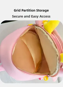 Pink plush kids backpack detail showing internal mesh divider and yellow plastic pull tab