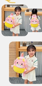 Detail view of the pink and yellow cartoon dragon backpack for toddlers and children