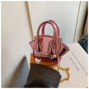 Detail of pink laser leather mini bag featuring gold chain and HOWL & BAGS logo