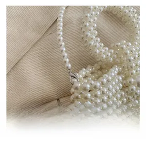 Detail of white pearl beaded bag with high-quality silver lobster clasp and hardware