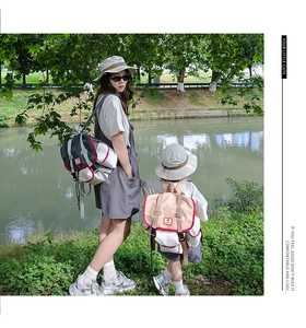 Detail of color-block canvas backpack featuring durable flap buckles for outdoor use