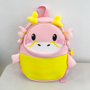 Detail of cute pink and yellow cartoon dragon plush backpack with 3D horns and wings
