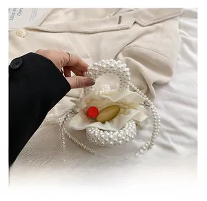 Detail showing pearl beaded handbag interior with drawstring pouch and lipstick
