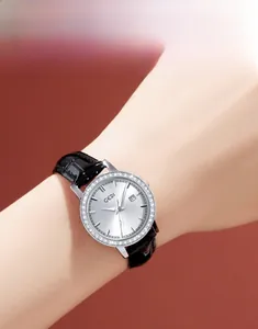 Close-up of elegant women quartz watch with crystal bezel and black leather strap