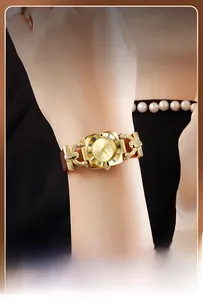 Close-up of a vintage square gold watch for women with brown leather strap and Roman numerals