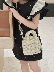Close-up of handmade pearl beaded handbag with drawstring satin lining and chain