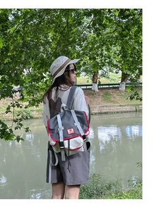 Outdoor shot of kids backpack with red trim and buckle straps for sports activities