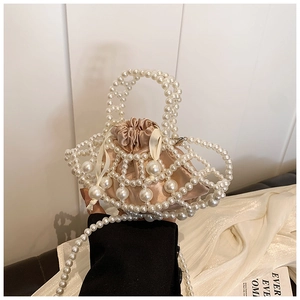 Detail of white pearl beaded bag with champagne satin drawstring liner and strap