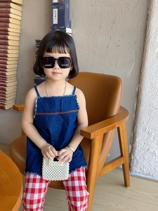 Detail of a white pearl beaded mini handbag paired with a blue denim girl top