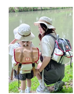 Outdoor view of parent-child backpack set with khaki color blocking and buckle closure