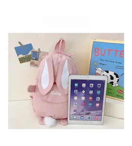 Pink rabbit toddler backpack size comparison with a standard tablet for scale