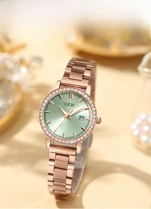 Close-up of rose gold stainless steel watch with green dial and rhinestone bezel