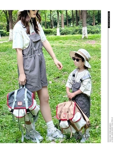 Outdoor lifestyle shot of parent-child color-block grey backpacks on green grass background