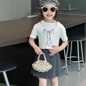 Girls fashion set with white bow t-shirt, pleated skirt and pearl beaded shell handbag