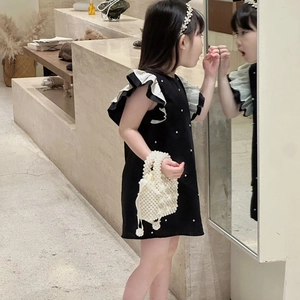Girl in black princess dress with pearl accents and matching beaded handbag for girls