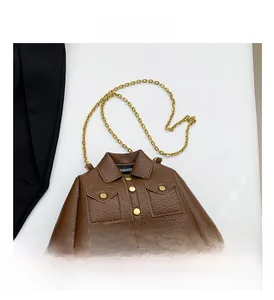 Detail of dark brown jacket-shaped mini crossbody bag with lychee grain texture and gold chain