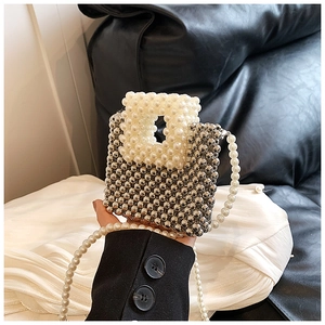 Detail view of woven beads mini bag with pearl handle and metallic silver finish
