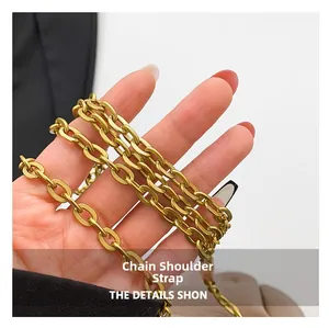 Close-up of golden metal chain strap with polished oval links for creative handbag