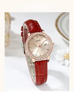 Close-up of luxury women's watch with red leather strap and sparkling rhinestone bezel