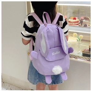 Detail of cute purple rabbit backpack for girls featuring plush tail and soft fabric