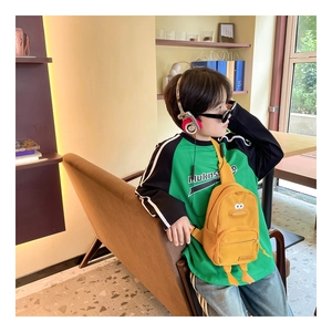 Détail du sac de poitrine canard jaune pour enfants avec pieds 3D et poche zippée principale