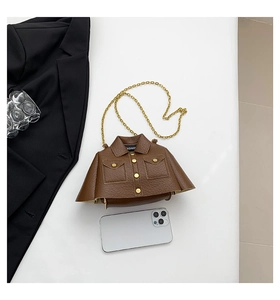 Detailed view of creative jacket-shaped crossbody bag with lychee texture and gold chains