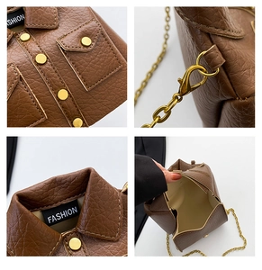 Macro view of jacket-shaped bag details, lychee texture, and golden chain hardware