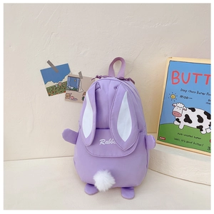 Detail of purple rabbit backpack with long ears, embroidery and plush pom-pom tail decor