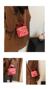 Detail of red and white plaid tweed mini bucket bag with leather chain and top handle