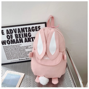 Close-up of pink rabbit backpack featuring long ears and soft plush pom-pom tail detail