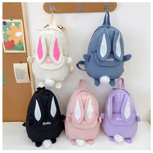 Detail of cute toddler backpacks with 3D rabbit ears and pom-pom tails in five colors