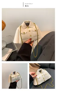Detail of jacket-shaped cream crossbody bag with lychee texture and gold chain strap