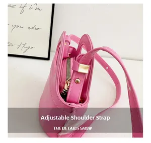 Detailed view of pink mini plaid handbag with metal zipper and adjustable strap