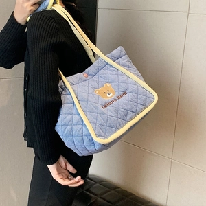 Quilted light blue canvas tote bag with cute bear embroidery and yellow trim handles