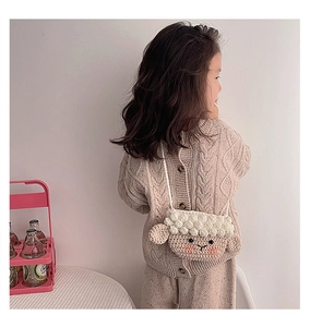 Détail du sac à bandoulière tricoté en forme de mouton pour enfant en laine blanche