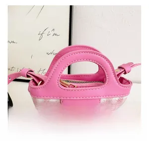 Detail of pink plaid mini handbag with gold MAHAR logo and leather stitching finish