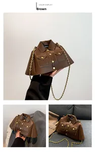 Detailed view of creative brown jacket-shaped bag with gold chain and metal buttons