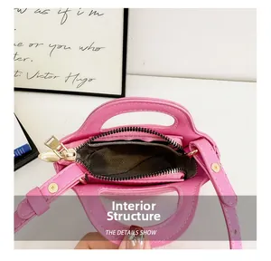 Top view of pink leather kids handbag showing internal structure and zipper compartment