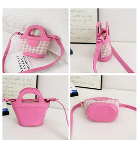Detail view of pink plaid mini handbag with leather straps and golden metal logo